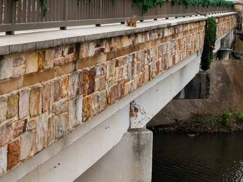 City bridge with a holiday wreath hanging on it as decoration. 