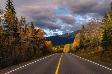 Road Through The Autumn Mountains Under A Cloudy Sky