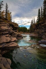 River Flowing Through Rocks Under A Cloudy Sky