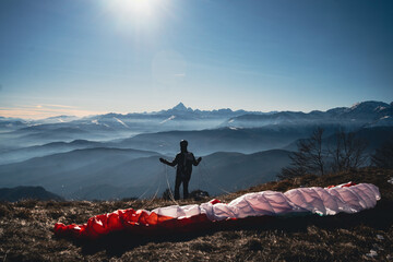 man in the mountains ready for Paragliding