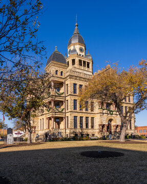 Ornate stone courthouse building in the central downtown square of Denton in Texas