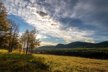 Cloudy Sunny Sky Over A Fall Field In The Mountains