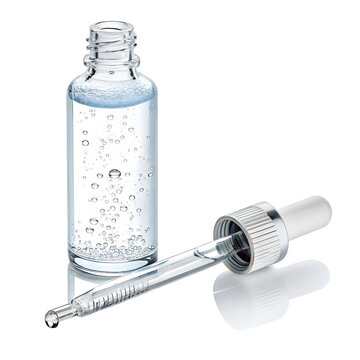 Clear glass bottle with dropper filled with serum and bubbles isolated on transparent background