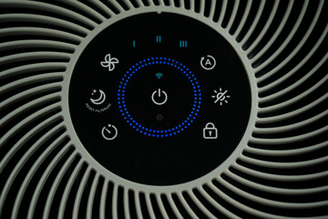 close-up (top-down) of the working air purifier, which releases fresh air (PM 2.5-free). It features touchscreen panel and modern solutions such as Wi-Fi and smart home