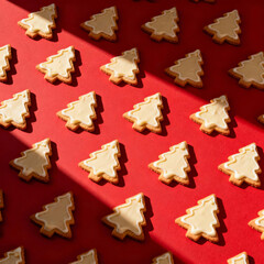 Tasty Christmas tree cookie on red background. Minimal Christmas background.