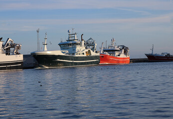 A vibrant and picturesque scene of traditional fishing boats moored in a Chilean coastal harbor