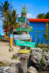 Weathered wood sign on Sorobon Beach in Lac Bay, a tropical lagoon with shallow turquoise waters on...