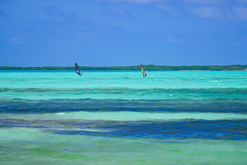 Windsurfers in Lac Bay, a tropical lagoon with shallow turquoise waters on the southeast coast of...