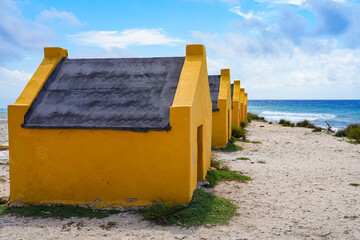 Historic red Slave Huts (Slave Houses) on the Salt Flats Coast of Bonaire in the Dutch Caribbean