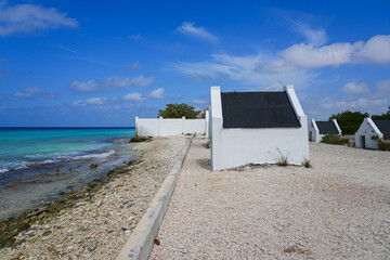 Historic white Slave Huts (Slave Houses) on the Salt Flats Coast of Bonaire in the Dutch Caribbean