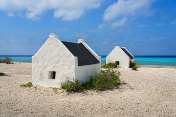 Historic white Slave Huts (Slave Houses) on the Salt Flats Coast of Bonaire in the Dutch Caribbean