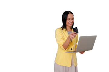 Young woman standing with laptop and credit card, smiling while completing secure online purchase — modern, convenient e-commerce transaction