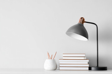 Modern desk lamp on stack of books with white background