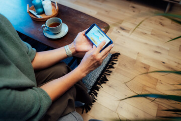 No face female using smartphone to check temperature setting of her smart home app. Smart control panel, managing temperature, air conditioning system. Modern technology, controlled home environment