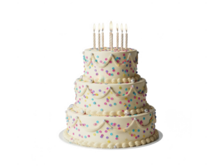 White cake with colorful polka dots and decorative frosting candles celebration