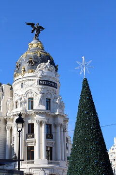 The Majestic Metropolis building next to Christmas treein Madrid city