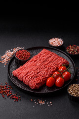 Raw ground beef or pork for burgers or meatballs with salt and spices. Raw ground beef