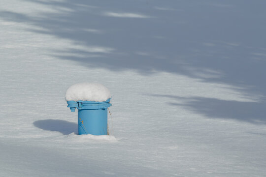 Drilled water well pipe and cap during winter.