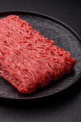 Raw ground beef or pork for burgers or meatballs with salt and spices. Raw ground beef