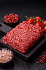 Raw ground beef or pork for burgers or meatballs with salt and spices. Raw ground beef