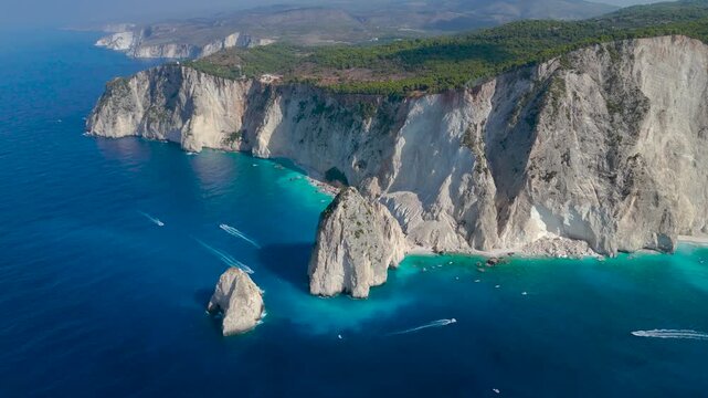 Aerial Drone View of Myzithres rocks in Zakynthos Greece featuring turquoise shallow sea sandy coves and the deep blue ocean stretching to the horizon