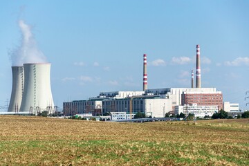 Cooling towers at nuclear power plant, energy self-sufficiency, greenhouse emission reduction and global warming concept