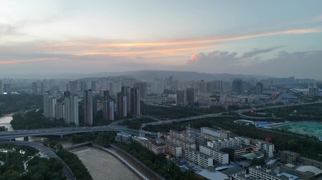 Xining City Aerial Shot at Nightfall - Urban Skyline with Mountains