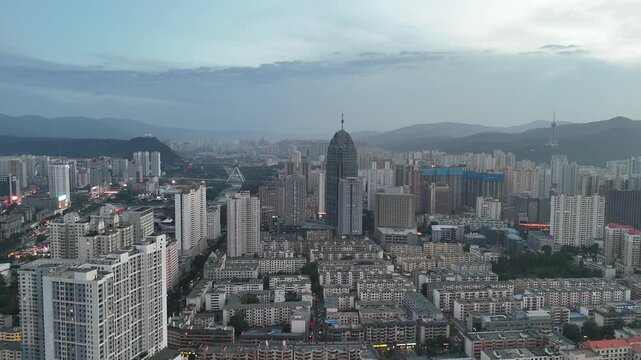 Xining City Aerial Nightfall Shot - Urban Skyline with Mountains