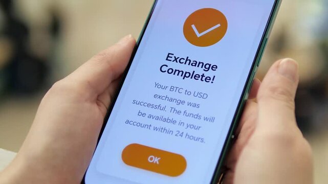 This shot focuses on the confirmation screen of a successful cryptocurrency sale (Bitcoin to USD), held in a public setting. It symbolizes accomplishment, realized gains, and the tangible result of