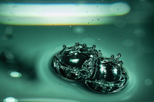 357.Dual Crown Splashes and Ripples on Green-Tinted Water