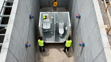 Footage of a prefabricated bathroom pod being carefully transported onsite showcasing the ease of installation and spacesaving features.
