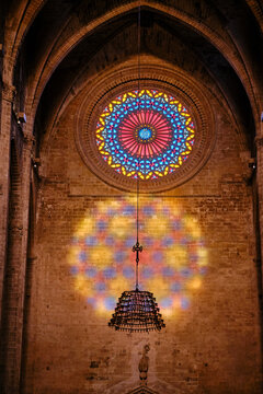 Sunlight creating colorful stained glass reflection inside old church
