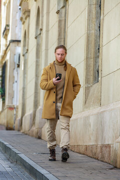 Man walking with phone on urban street