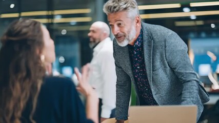 Medium shot of a professional discussing relocation packages with a multinational candidate in a modern office emphasizing crossborder employee mobility and global hiring