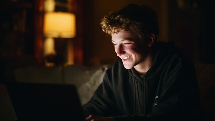 A joyful young individual immersed in the glow of a laptop screen, highlighting moments of engagement and excitement during late-night online activities amidst a cozy indoor setting.