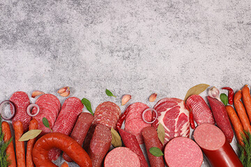 Selection of various smoked and dry-cured sausages, sliced salami, and spices on a kitchen counter. Advertising and menu for a store, banner for a cafe or restaurant.
