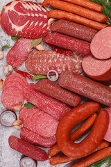 Delicious, aromatic appetizers of various salamis for the holidays. A selection of various smoked and dry-cured sausages and spices on a kitchen background. Advertising and menu for a store,