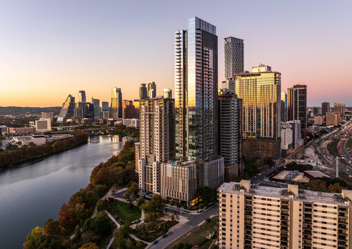 Aerial panoramic skyline of Austin Texas from the east at dusk or sunset in December 2025 with fall colors and clear sky