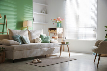 Living room with comfortable sofa and decor. Interior design