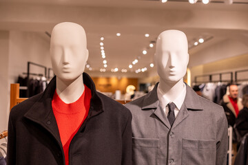 Mannequins displaying menswear fashion in clothing store