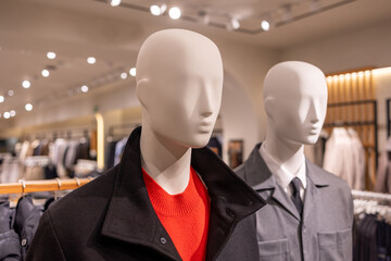 Faceless man mannequins displaying fashion clothing in a retail store