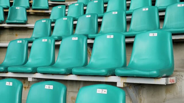 green seats in row in stadium without the player and the audience. Empty stadium or race track seats