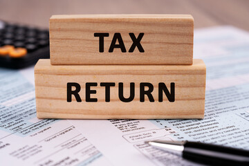 Tax Return text on wood block business concept