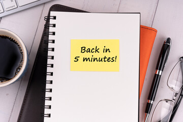 Notepad with text back in five minute