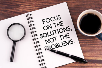 Notepad with inspirational quotes focus on the solutions, not the problems