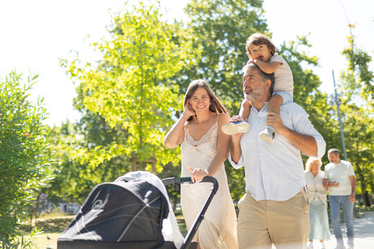 Multi-generational family walking together enjoying park stroll