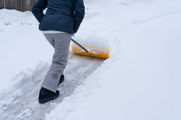 shoveling the snow on driveway