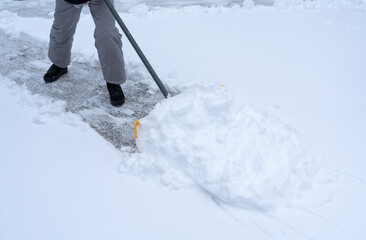 shoveling the snow on driveway