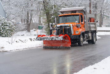 snowplow driving on residential street