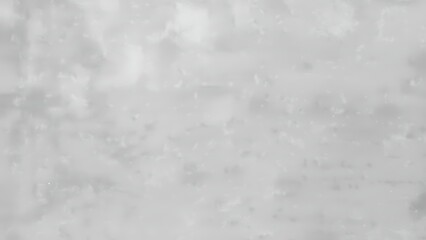 A blurry gray and white image with pixelated texture and no clear objects or features